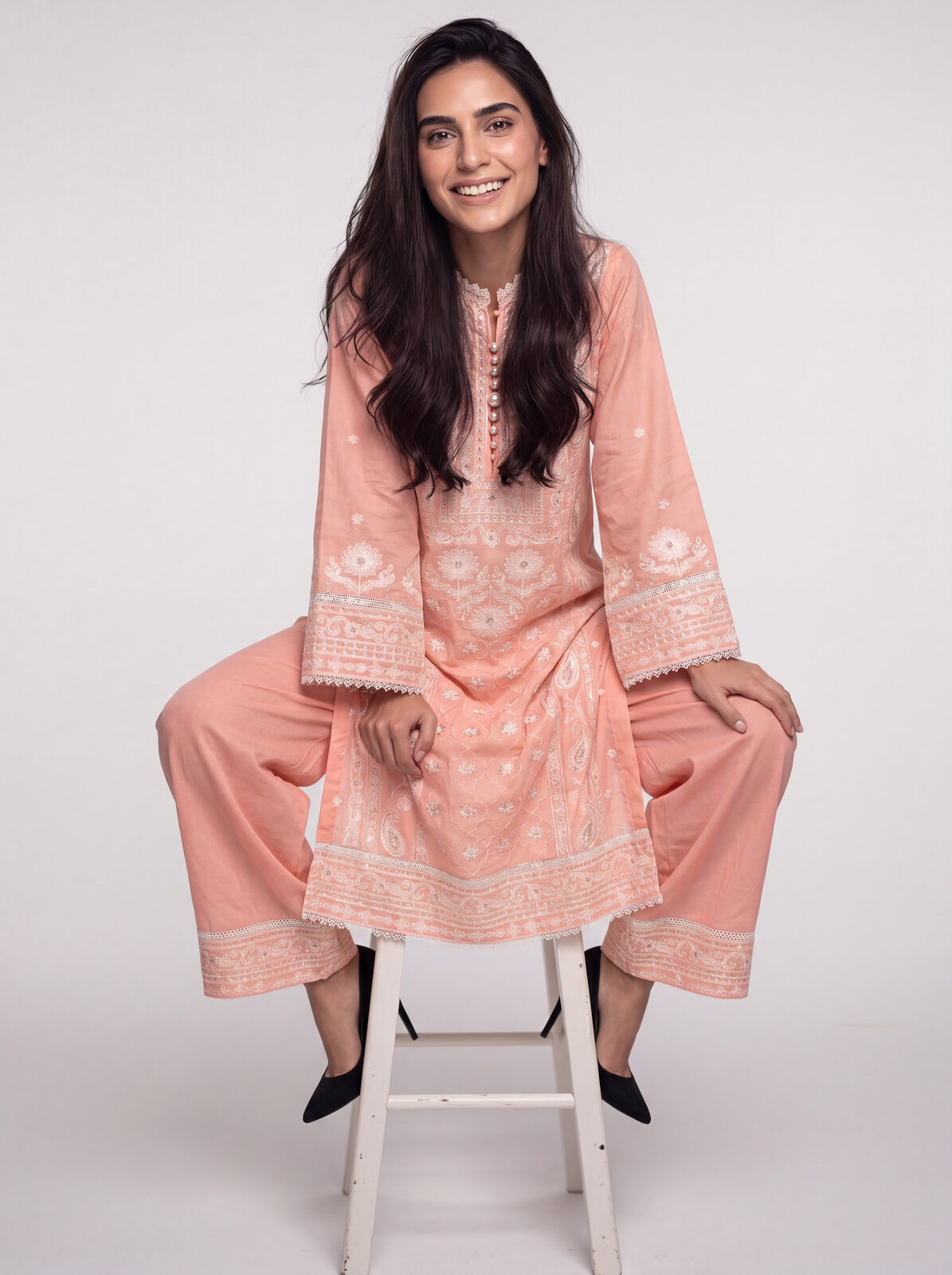 Blush kurta — seated on stool